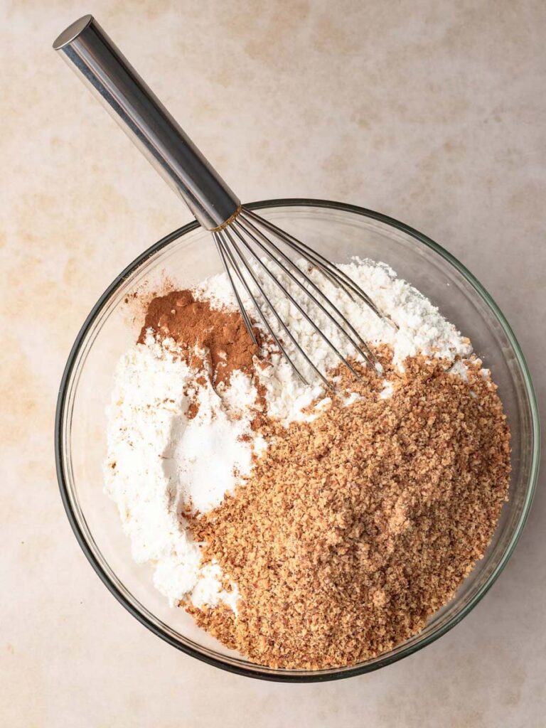 Mixing flour with ground walnuts and cinnamon.