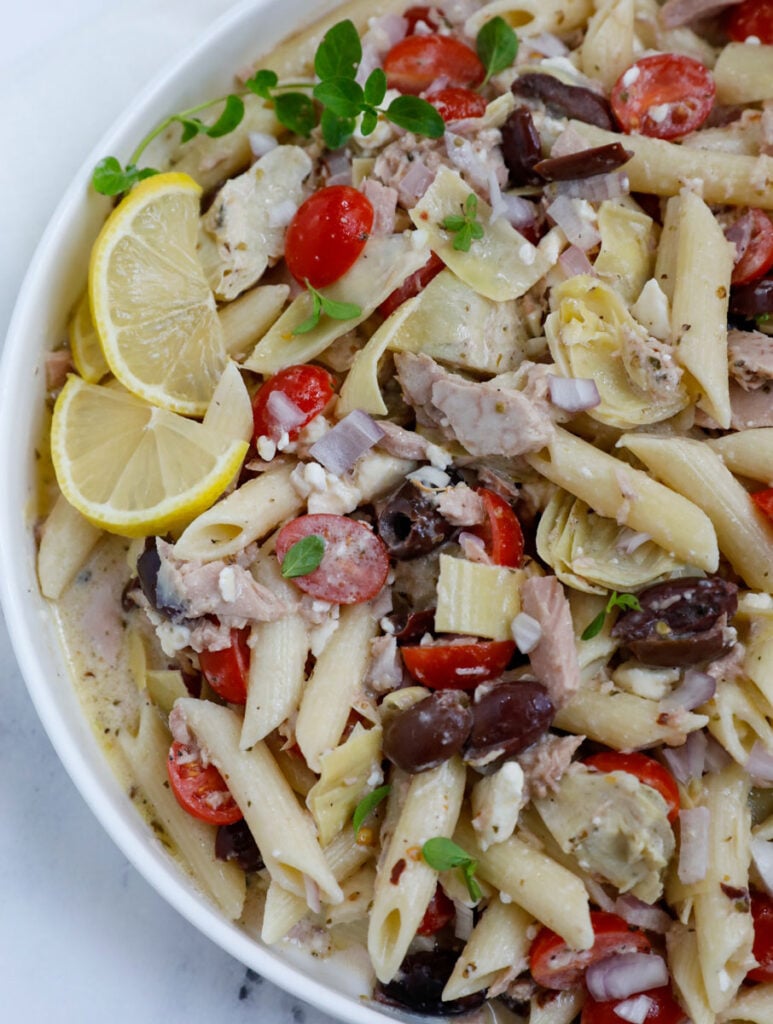 Overhead view of tuna pasta salad recipe in a big white bowl. 