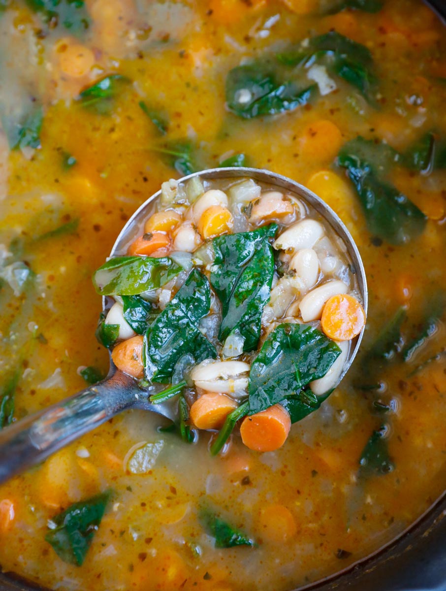 A ladle of Tuscan white bean soup.