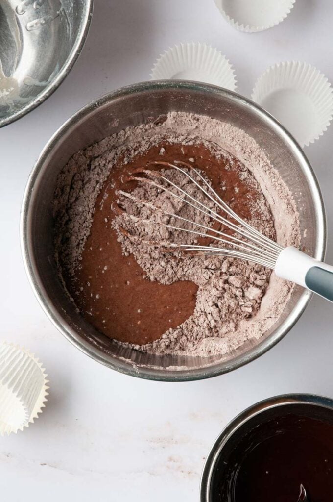 dry cake mixture being mixed with wet mixture in a bowl