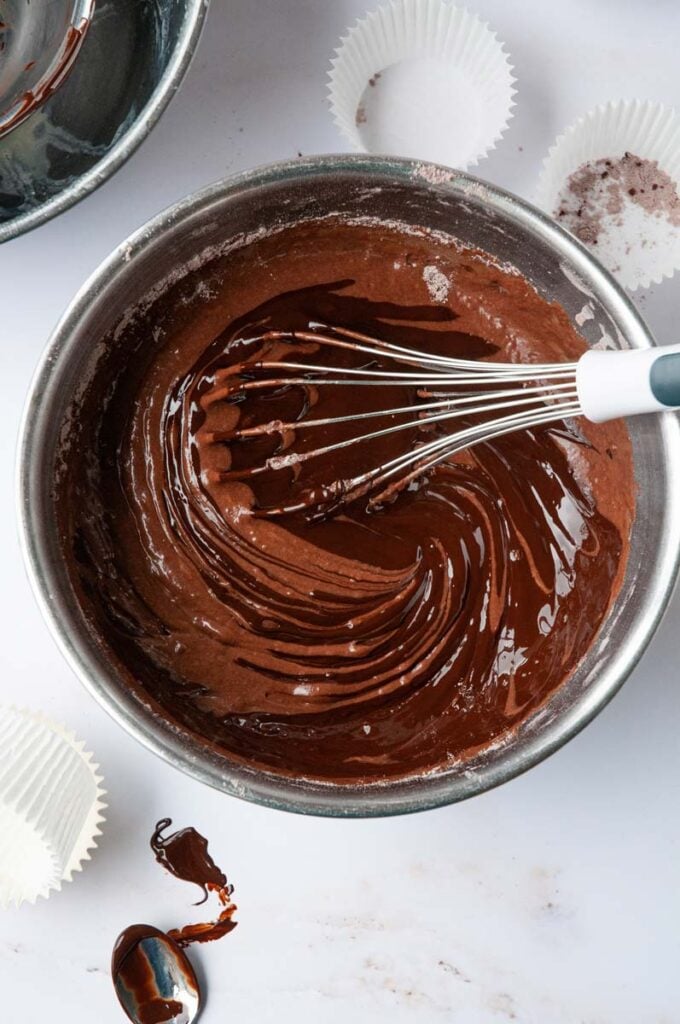 melted chocolate being mixed into the cake batter