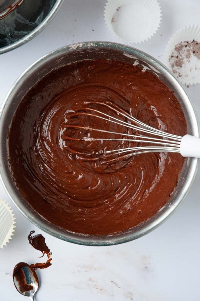 top down view of the cake batter in a bowl with a whisk inside