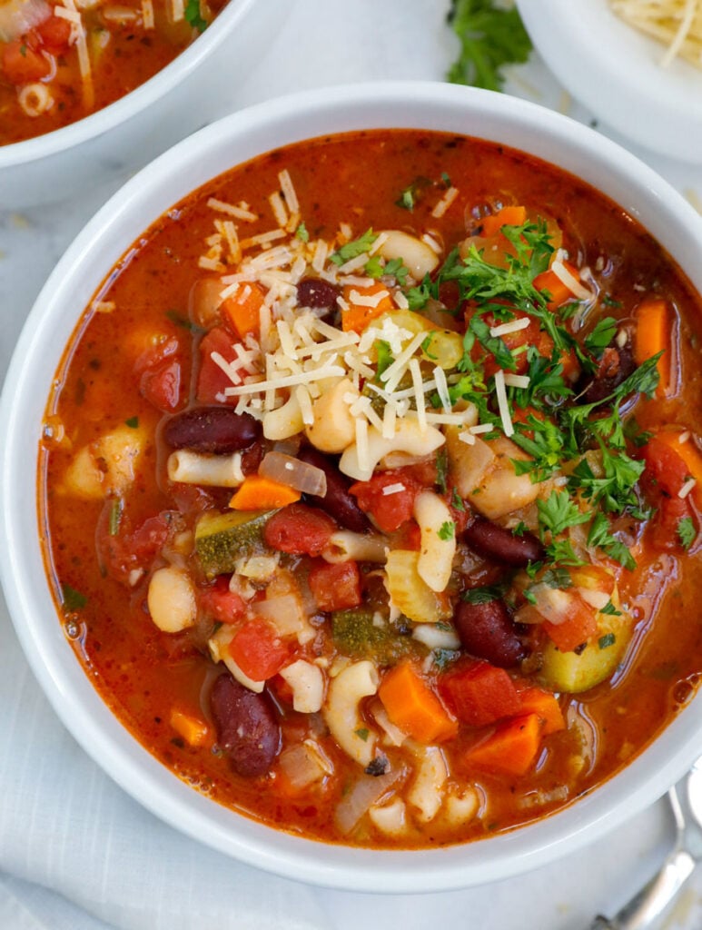 Top down view of a bowl of vegetable minestrone soup.