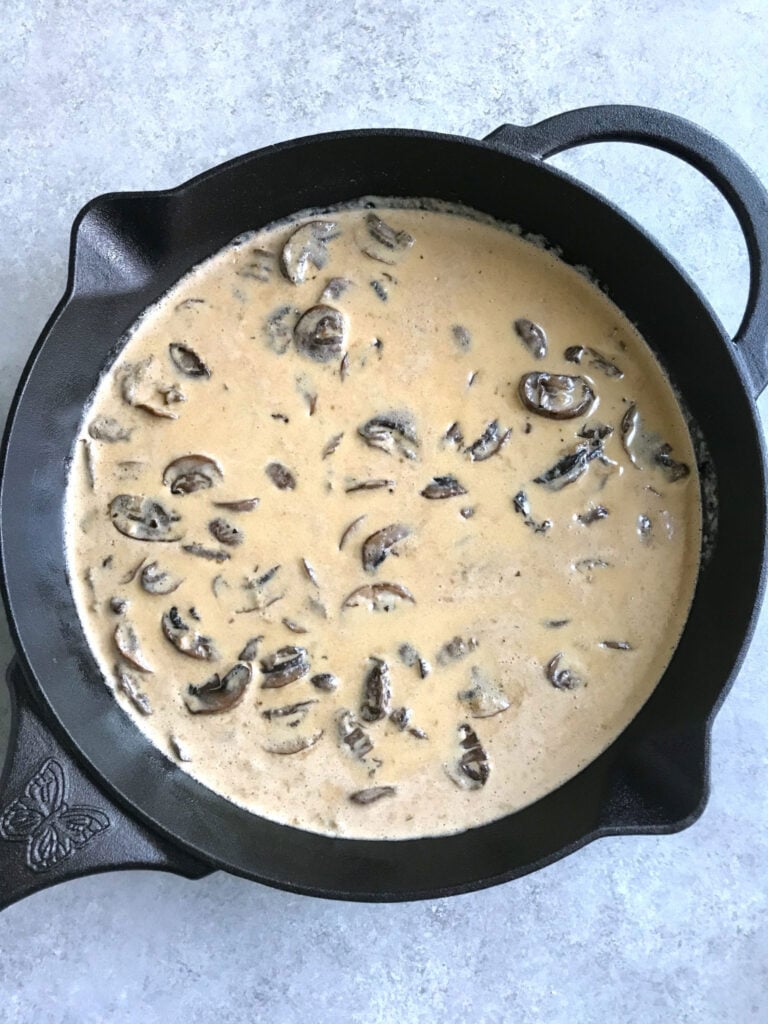 creamy mushroom sauce in a cast-iron skillet