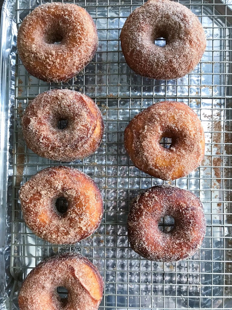  Cinnamon Sugar Donuts on a wire rack.