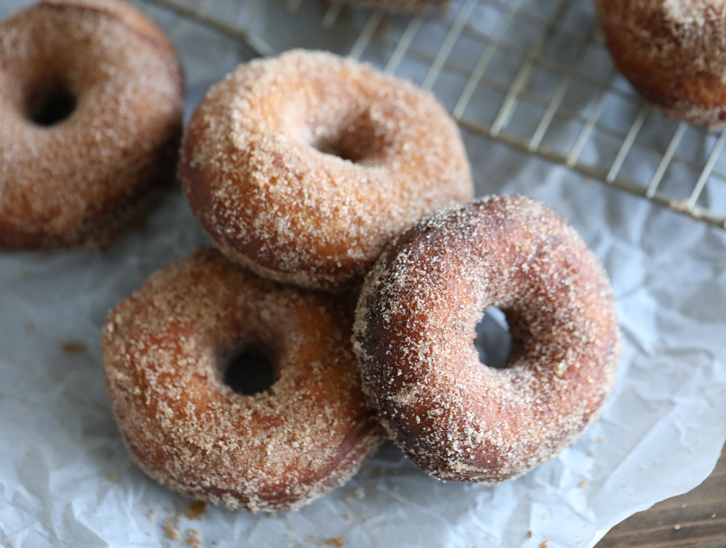 batch of donuts on parchment.