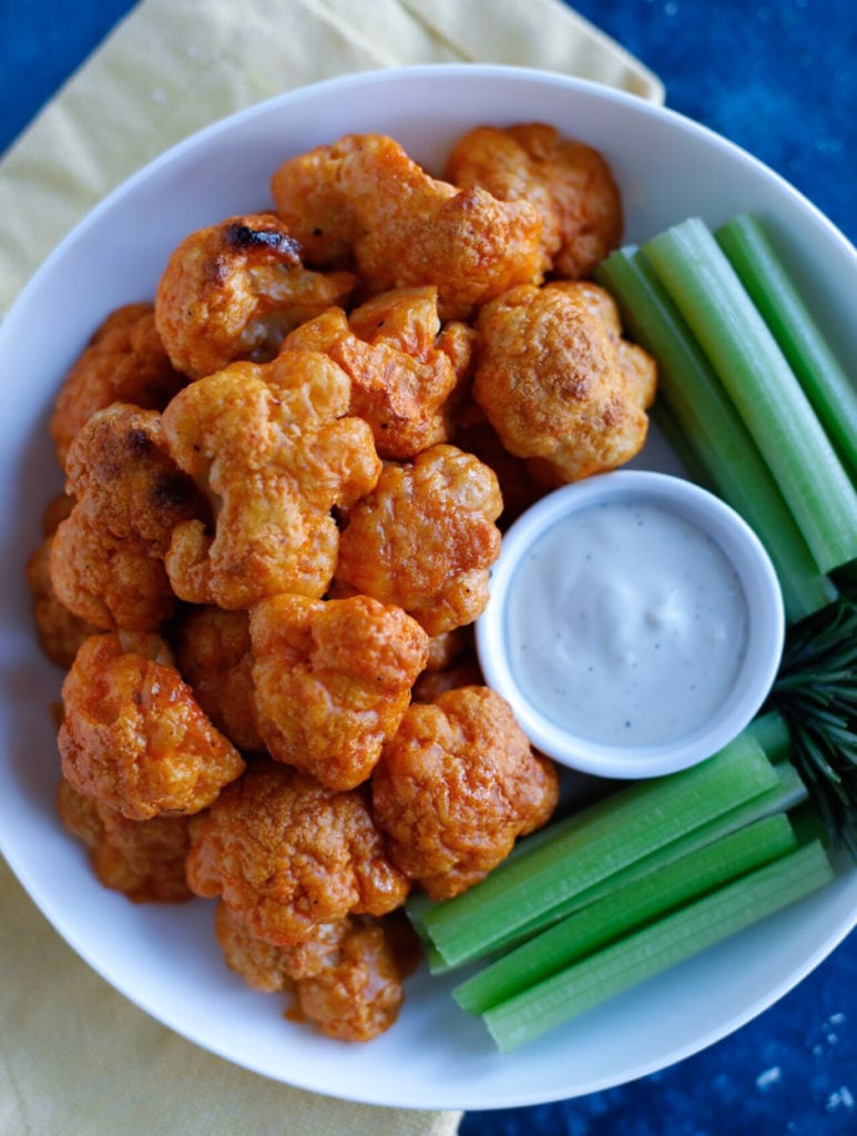 Buffalo Cauliflower Wings on a plate with dip 