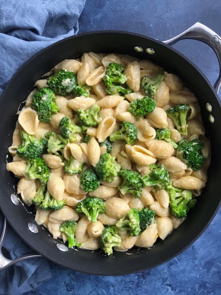 Creamy broccoli mac and cheese in a skillet.