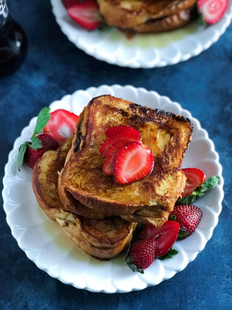 A stack of strawberry nutella french toast on a plate.