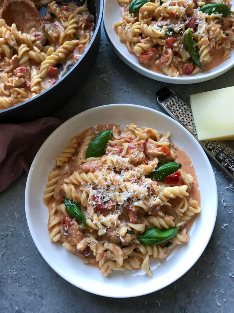 top down shot of creamy tomato pasta in a bowl