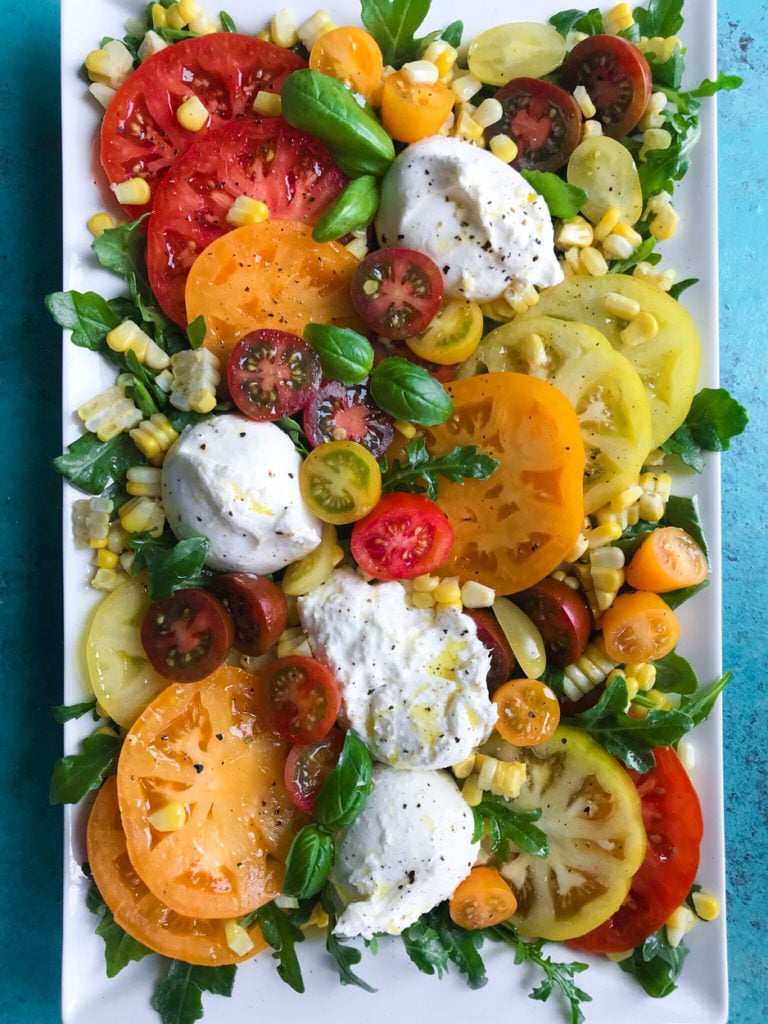 top down shot of Tomato and Burrata Salad on a plate