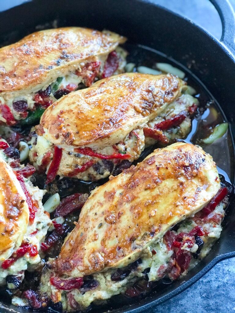 Cheesy Sundried Tomato Stuffed Chicken in a skillet