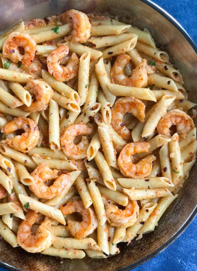 Creamy Shrimp Penne Pasta With Red Pepper Sauce in a skillet