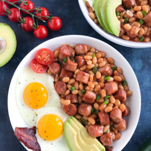 Baked Beans and Sausage in a white bowl.