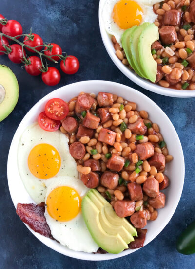 Baked Beans and Sausage in a white bowl.