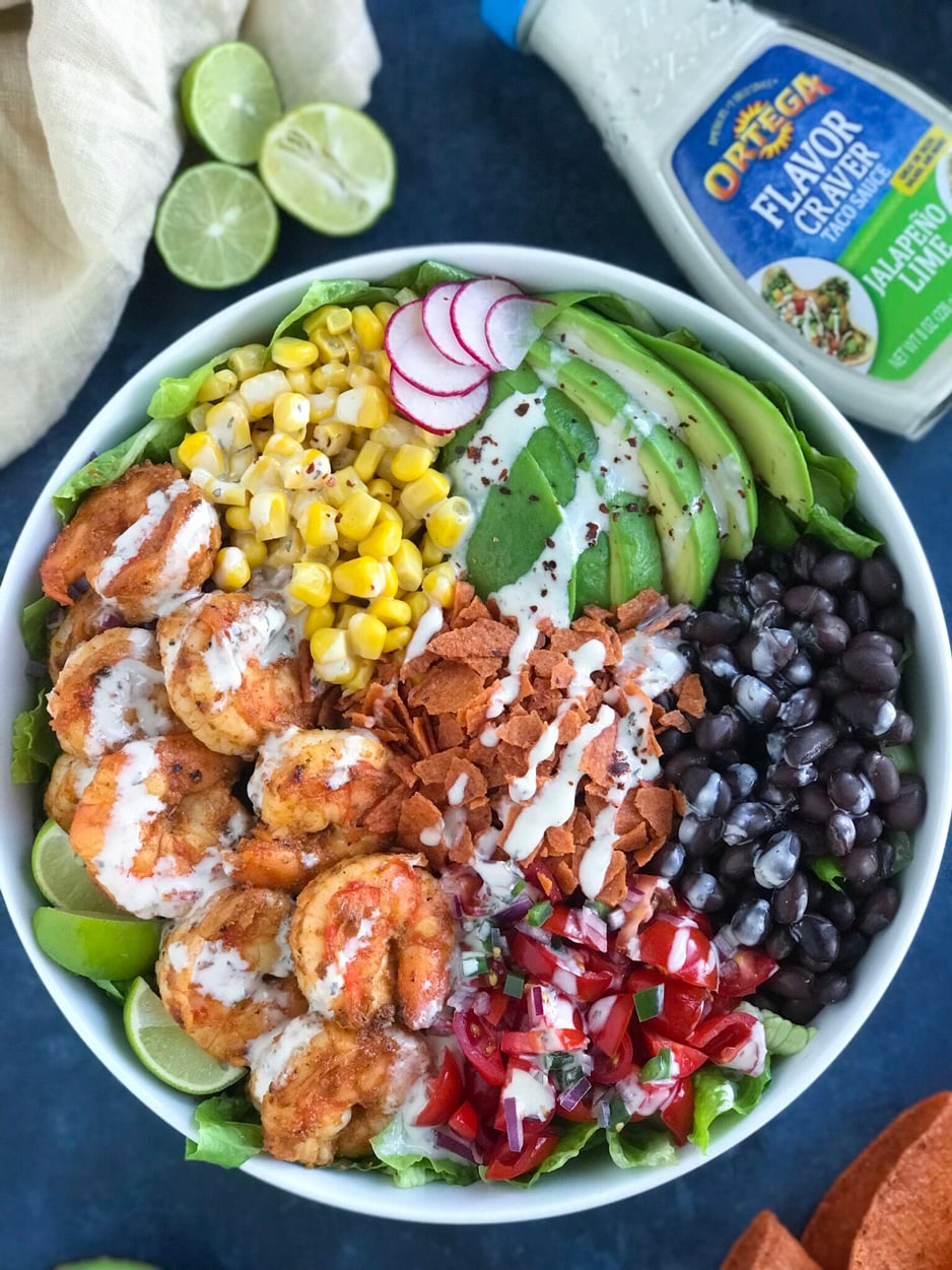 Shrimp Taco Bowl Shrimp Taco Bowl being topped with a delicious sauce to make it juicy