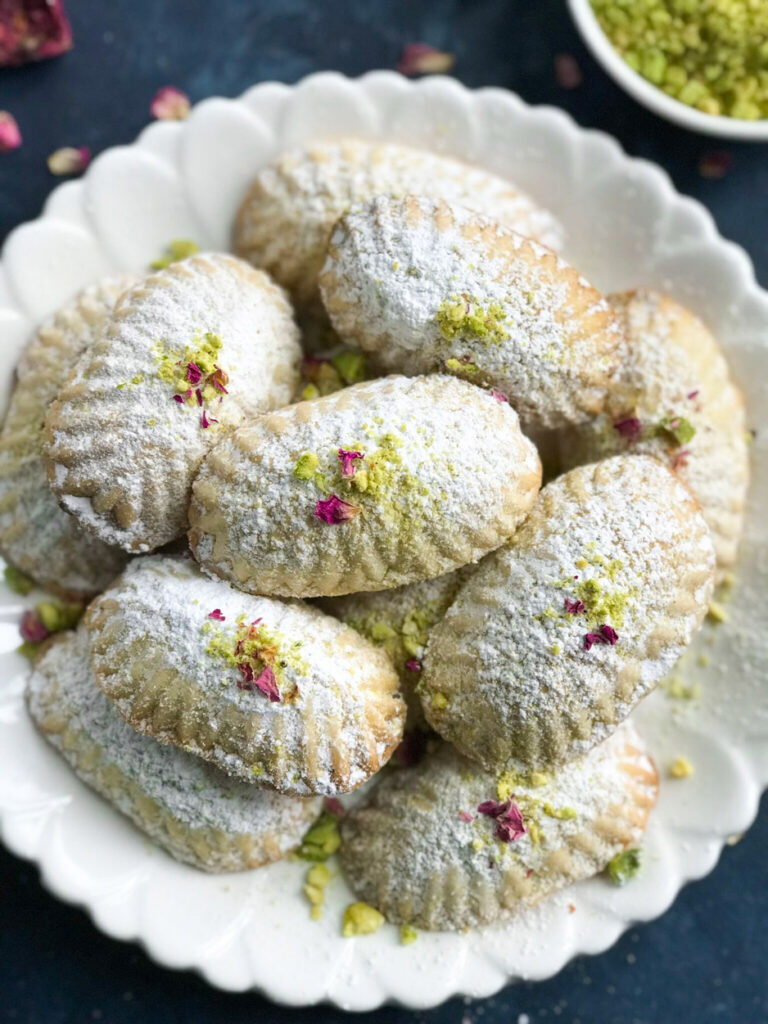 Pistashio Maamoul Cookies ( معمول بالفستق ) on a white plate