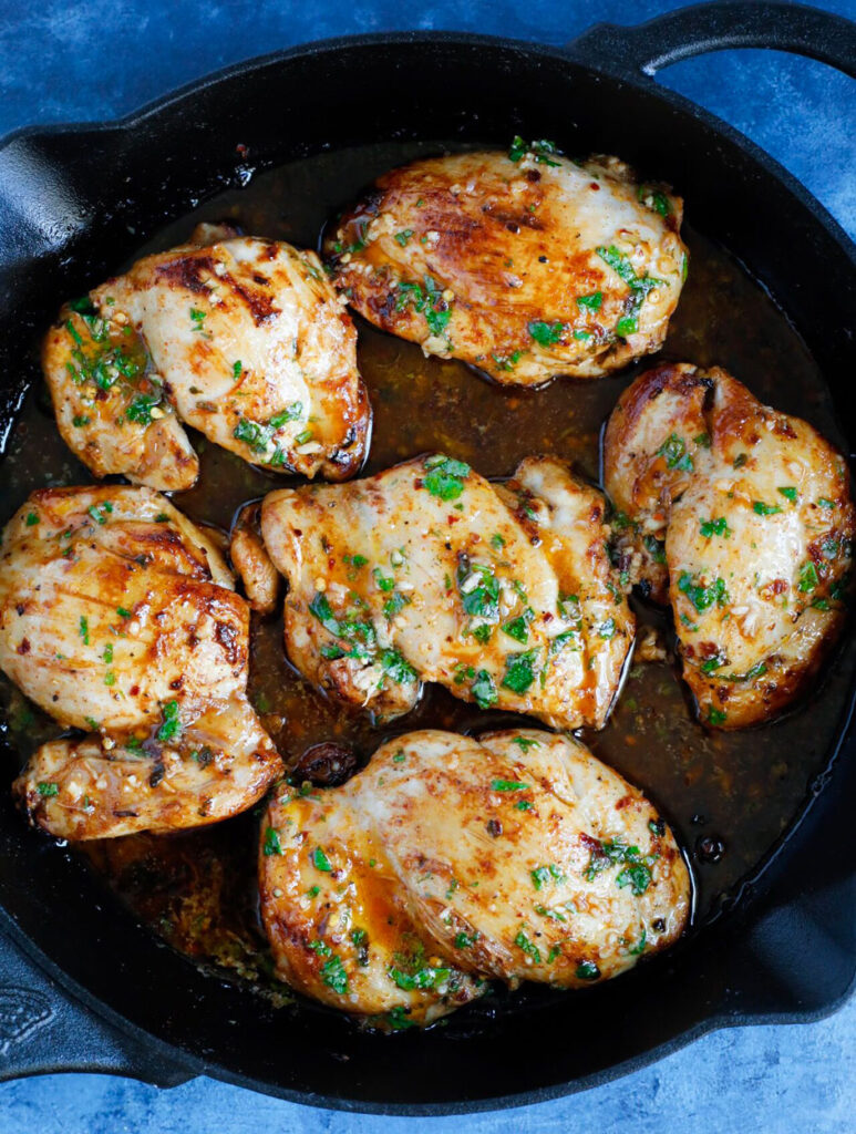 Spicy Sriracha Chicken cooking in a skillet