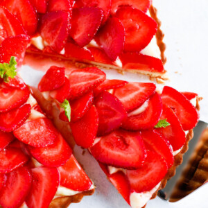 Strawberry French Tarte with a slice being taken out.