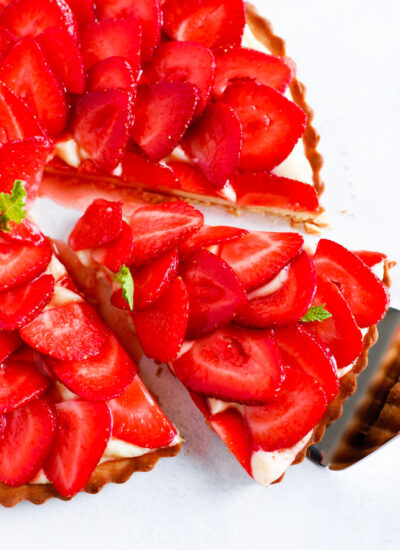 Strawberry French Tarte with a slice being taken out.