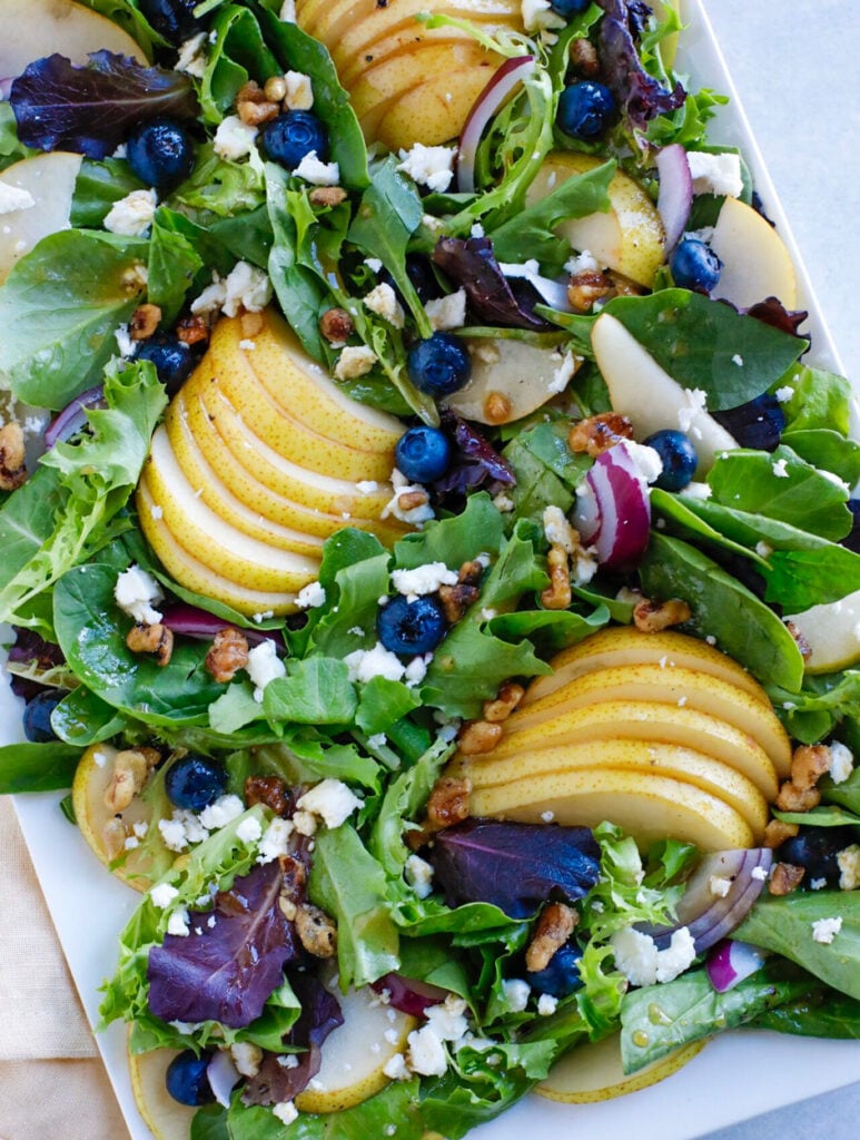 Autumn Pear Salad fall salad on a white plate.