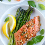 Baked Honey Garlic Salmon serve with a side of veggies, pasta, potatoes