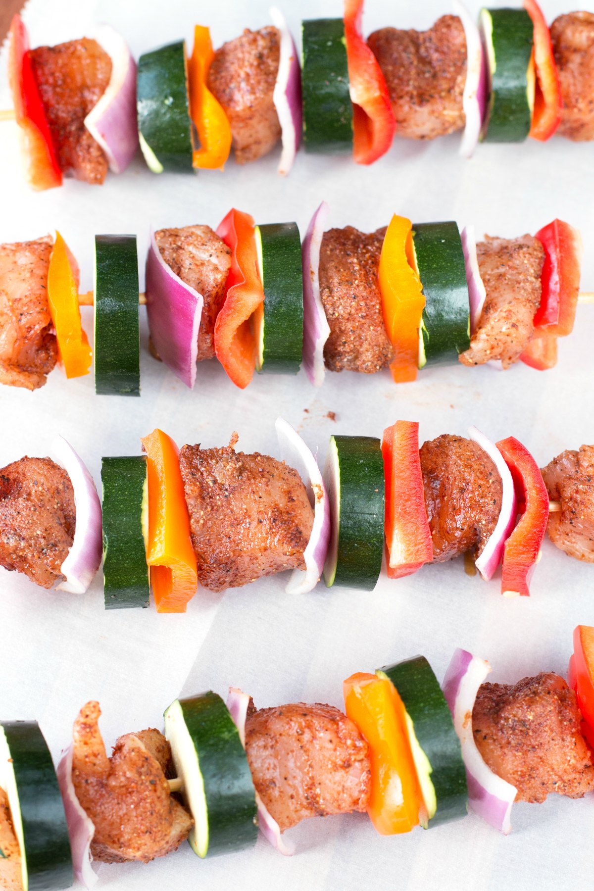 Chicken skewers with vegetables seasoned and waiting to be cooked