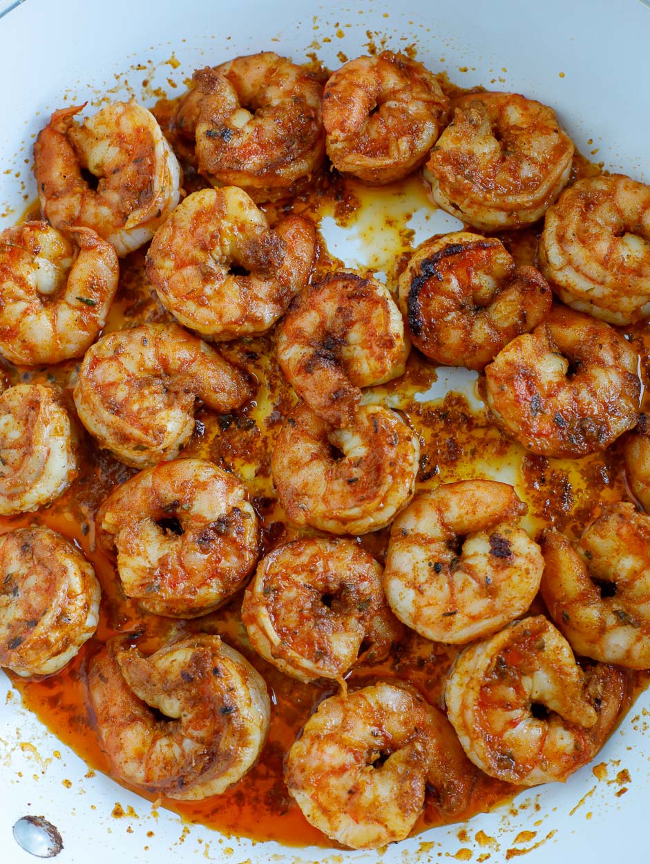 shrimp sautéed in a white skillet