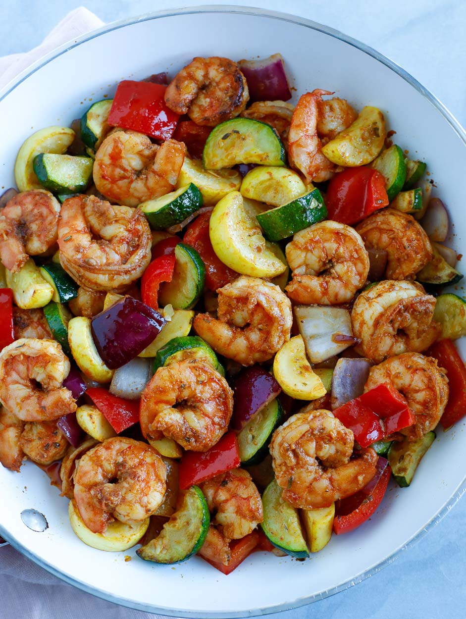 Shrimp and Vegetable cooked in a white skillet.