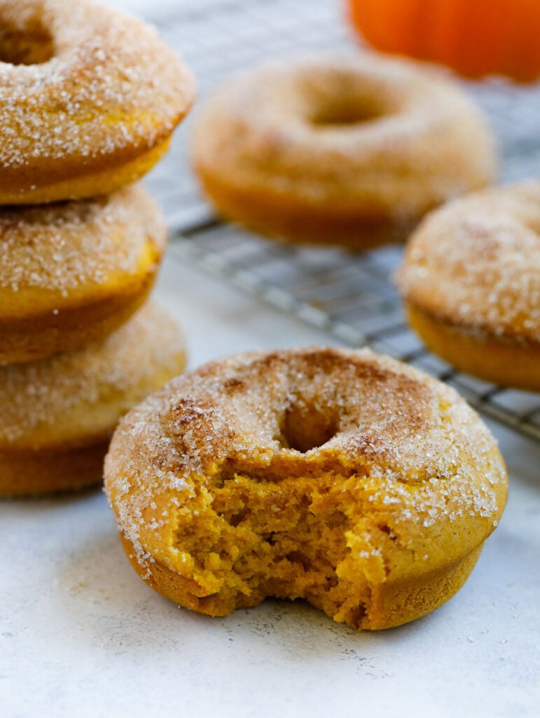 baked pumpkin donut with bite taken out