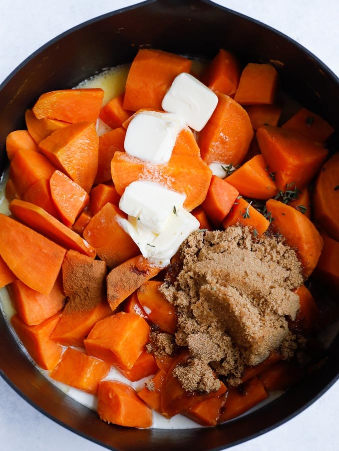 sweet mashed potatoes sweet potatoes with milk, sugar and butter in a pan