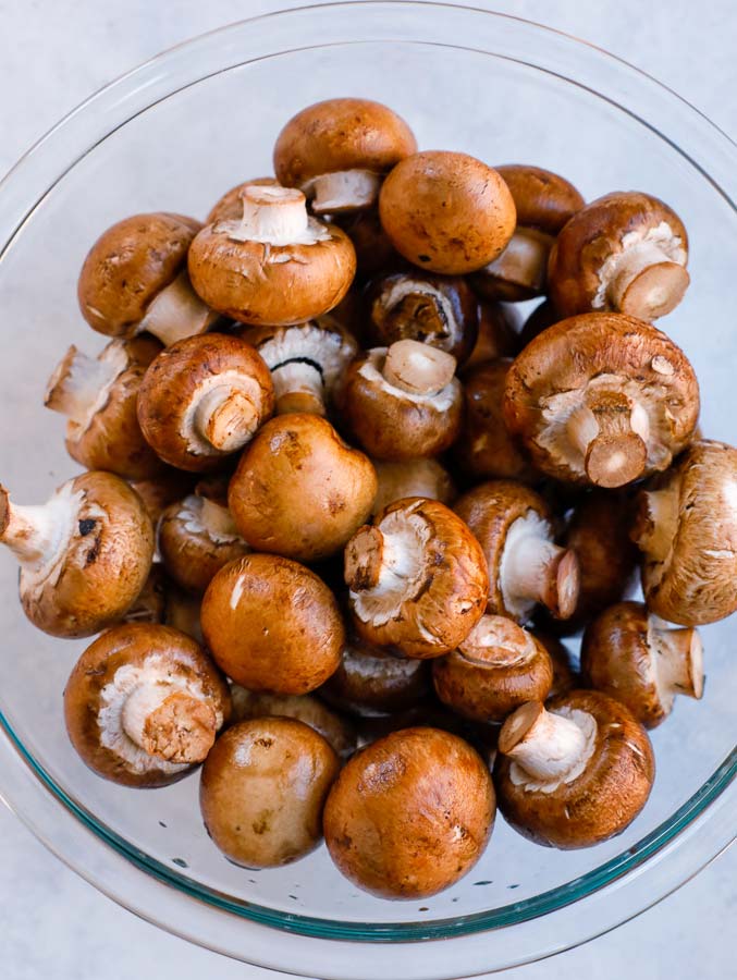 mushrooms Top down shot of cremini mushrooms in a glass bowl.