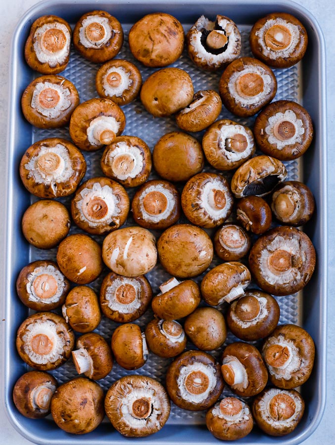 cremini mushrooms Overhead shot of mushrooms on a baking sheet.