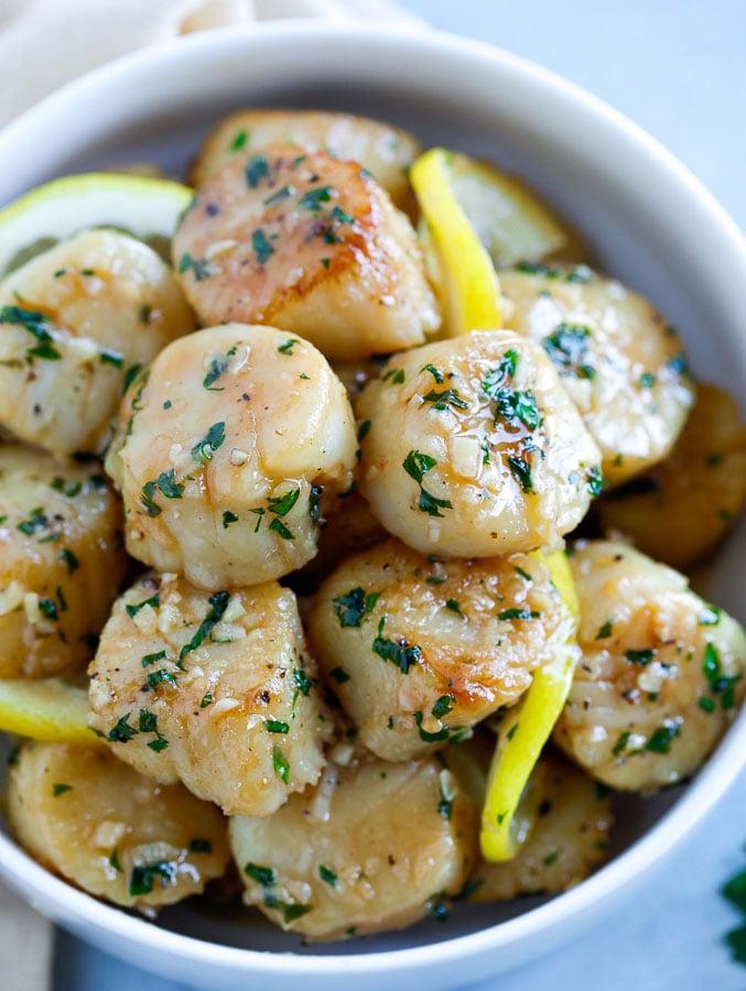 batch of garlic butter scallops in a bowl