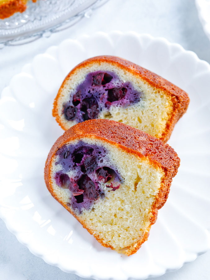 Slices of blueberry cake on a white place. 