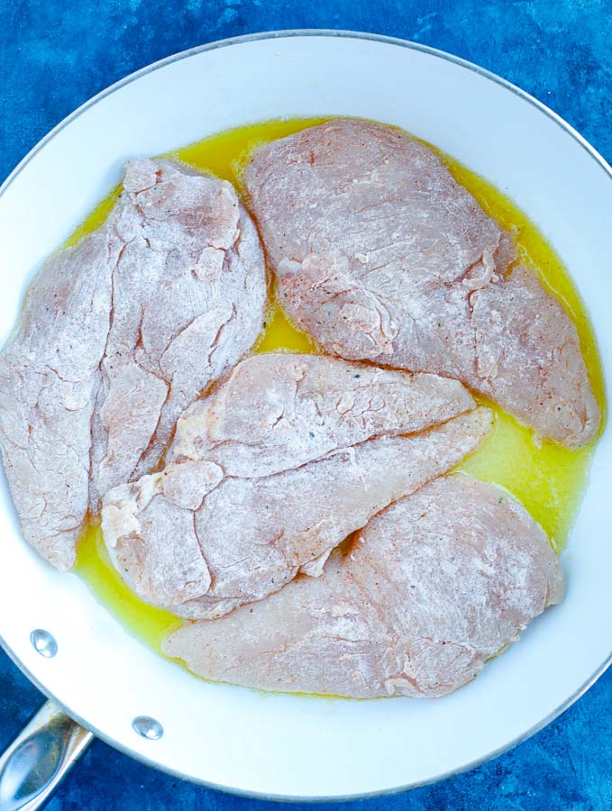 Raw chicken in a skillet