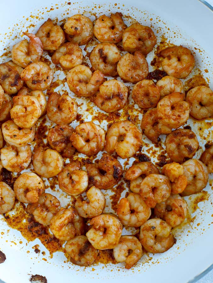 Southwest seasoned shrimp cooking in a skillet.