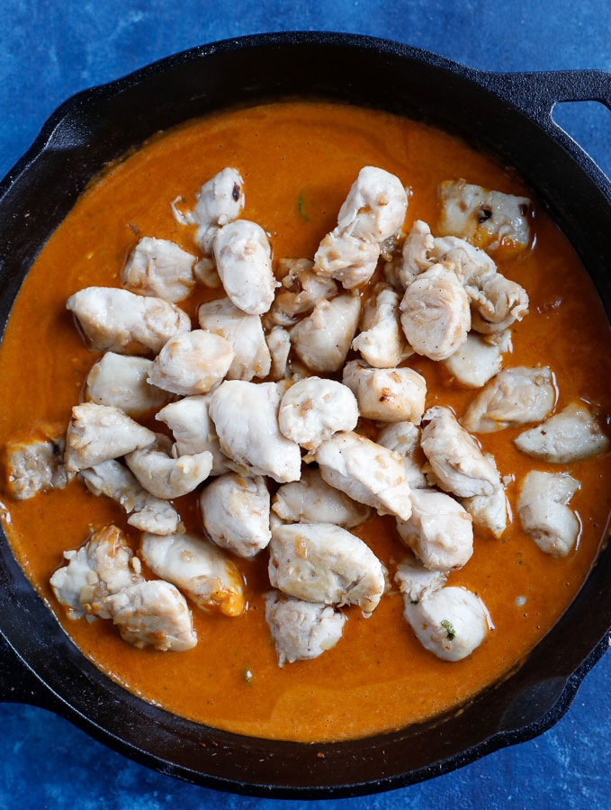 chicken cooking in curry sauce