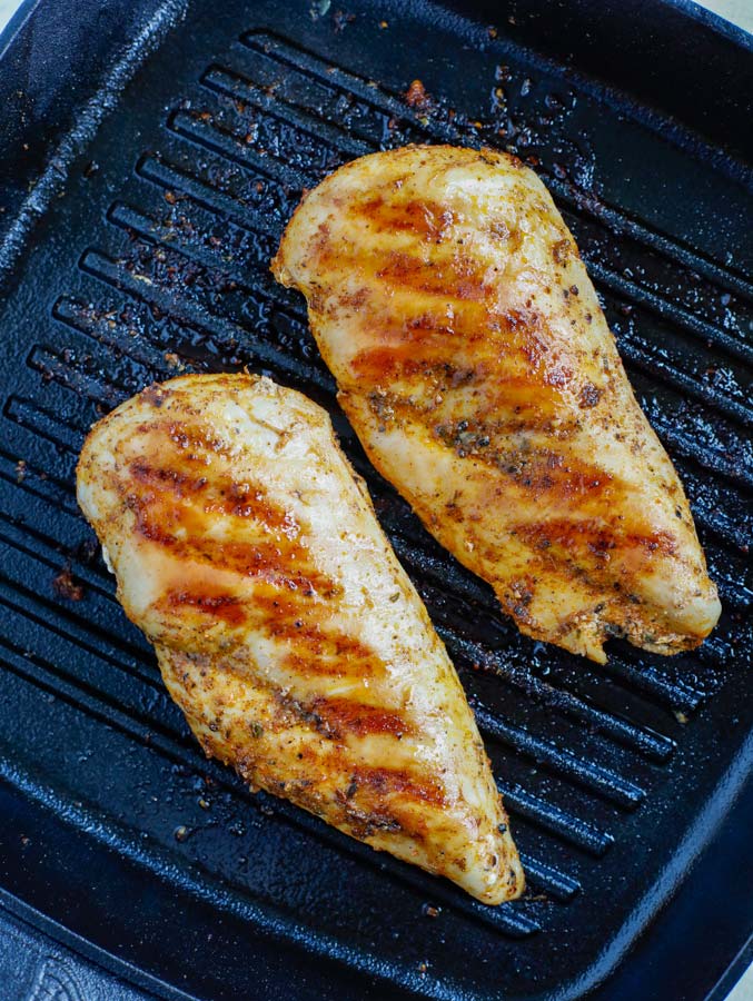 Marinated chicken cooking in a grill pan.