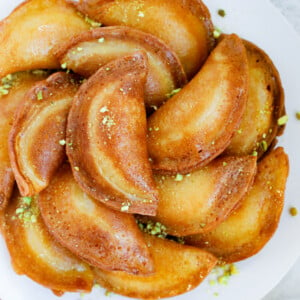 Fried atayef garnished with ground pistashios