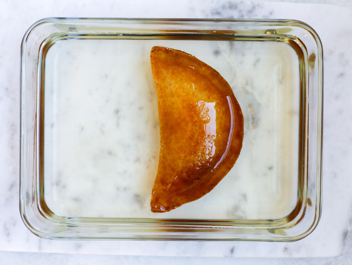 fried atayef dipped in sugar syrup