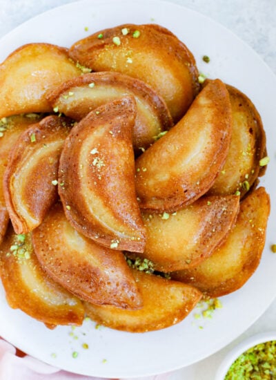 Fried atayef garnished with ground pistashios