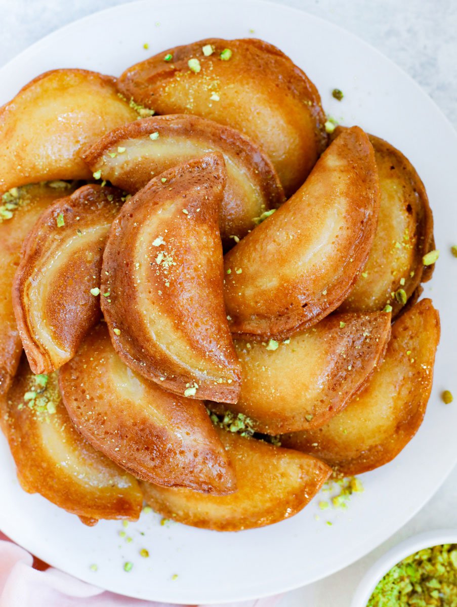 finished Atayef placed on a plate and garnished with pistachios