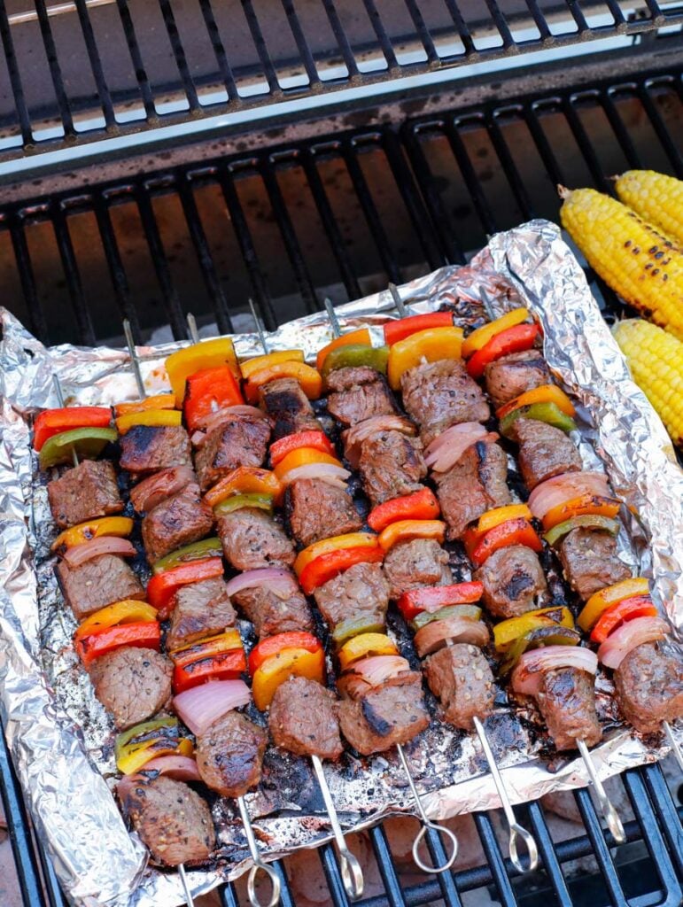 Beef kebobs on foil on the grill