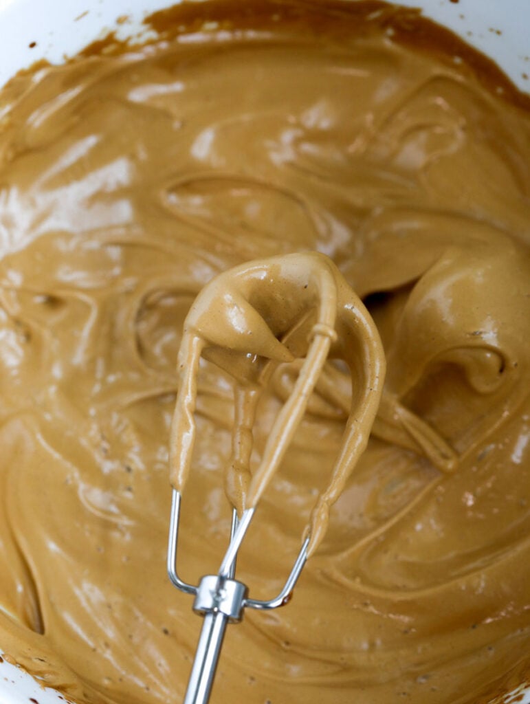 whipped coffee in a bowl with a whisk