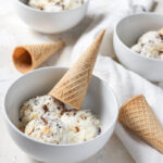 almond joy ice cream in a bowl topped with a cone