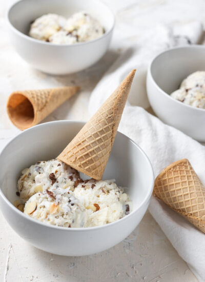 almond joy ice cream in a bowl topped with a cone