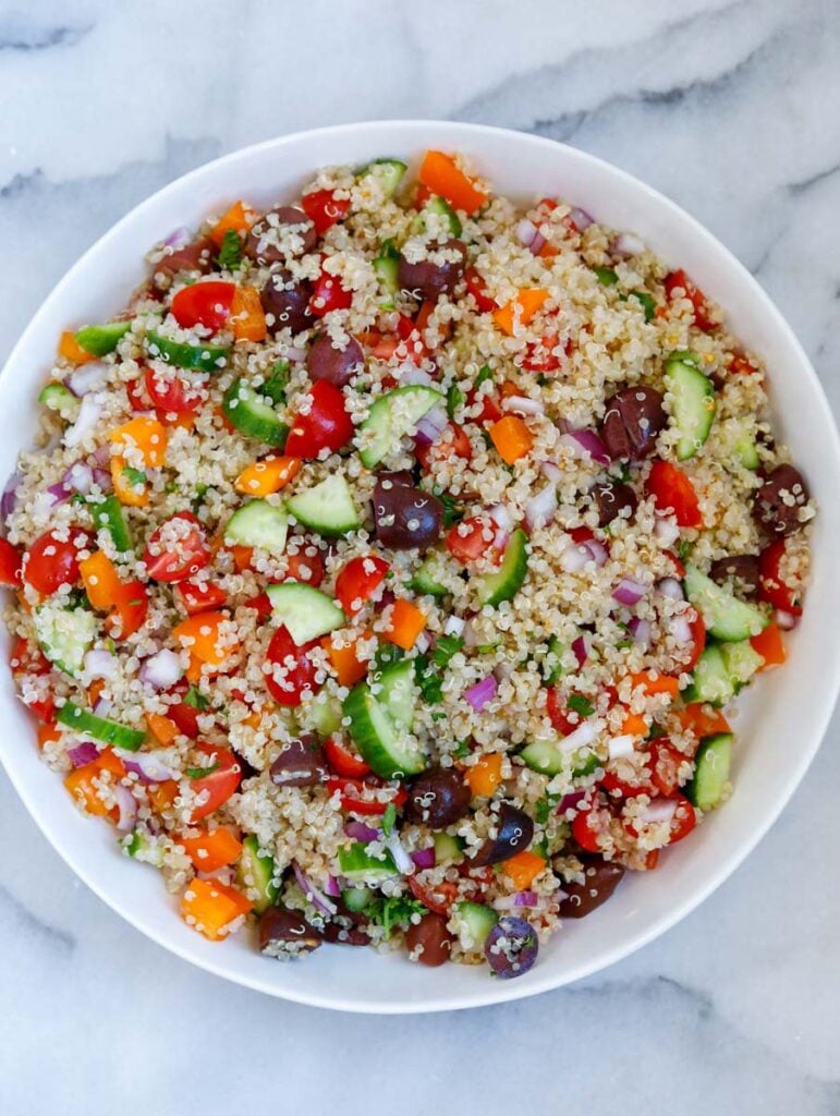 all the ingredients of the mediterranean salad mixed up together in a bowl