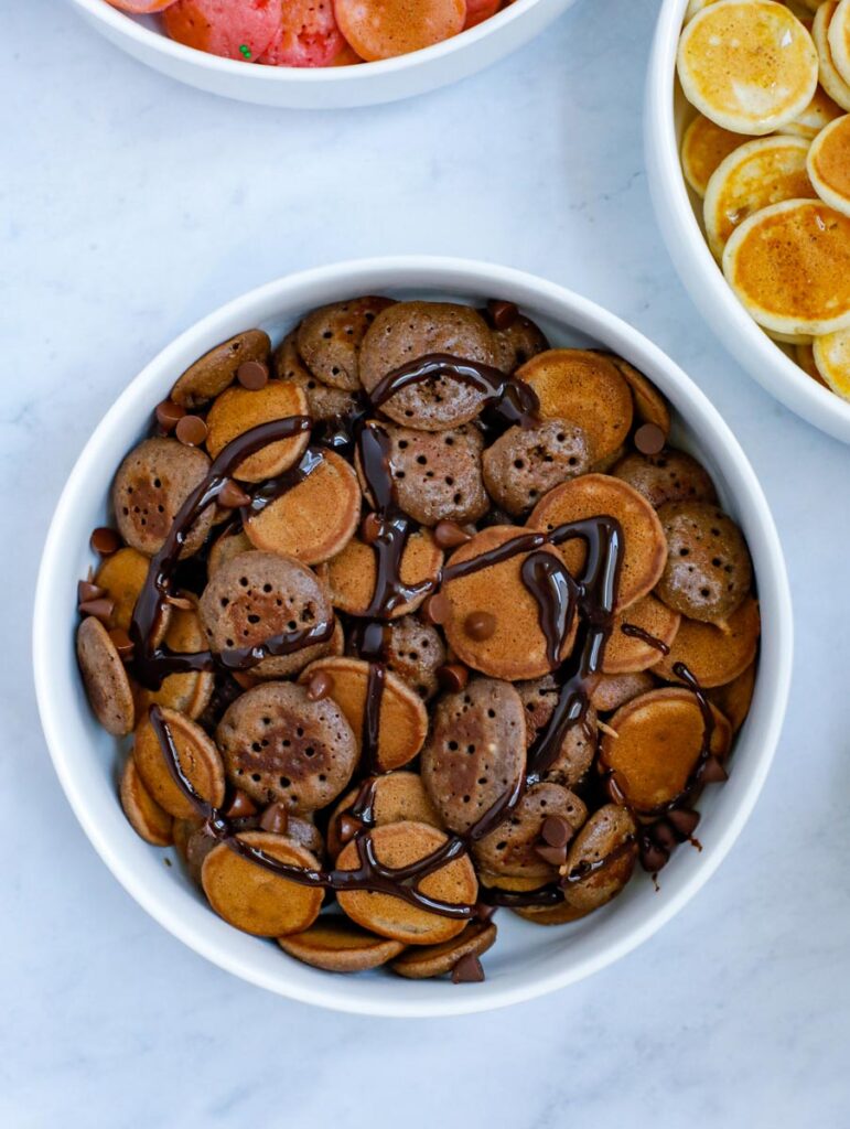 mini chocolate pancake cereal served with chocolate syrup and chocolate chips