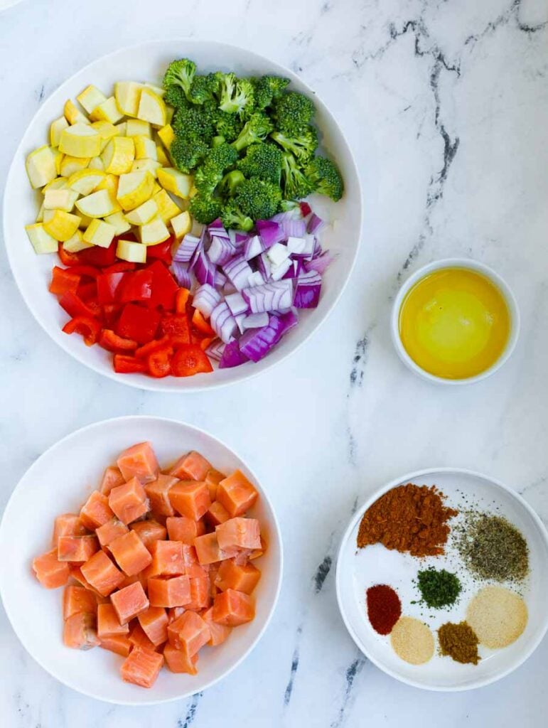 Ingredients of salmon and vegetables layed out on a table